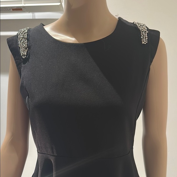 Black Sleeveless Peplum Blouse with Embellished Shoulders - Picture 2 of 7